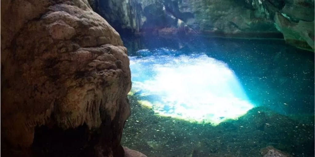A clear pool of 30 feet in diameter at the Blue Grotto which reflects the sunlight that streams through a hole at the top of the cave.